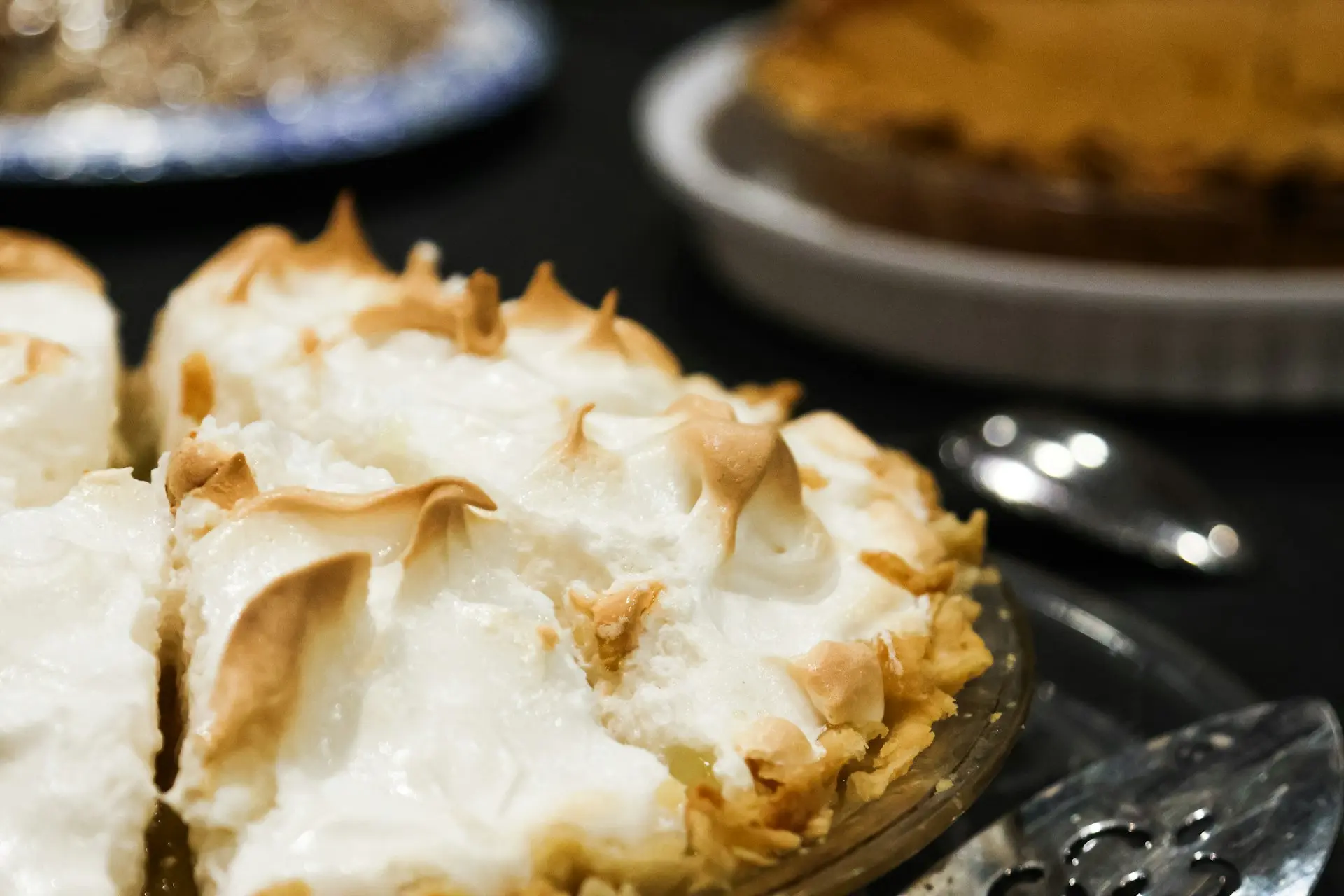 Close-up of a meringue pie with toasted peaks.